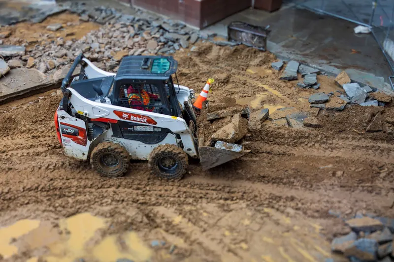 Skid steer on cleanup duty